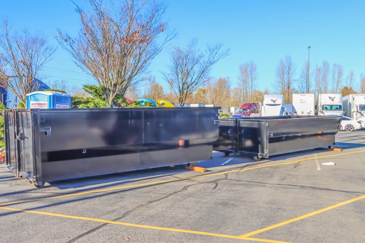 Professional dumpster rental service with roll-off container on residential driveway in Rupert